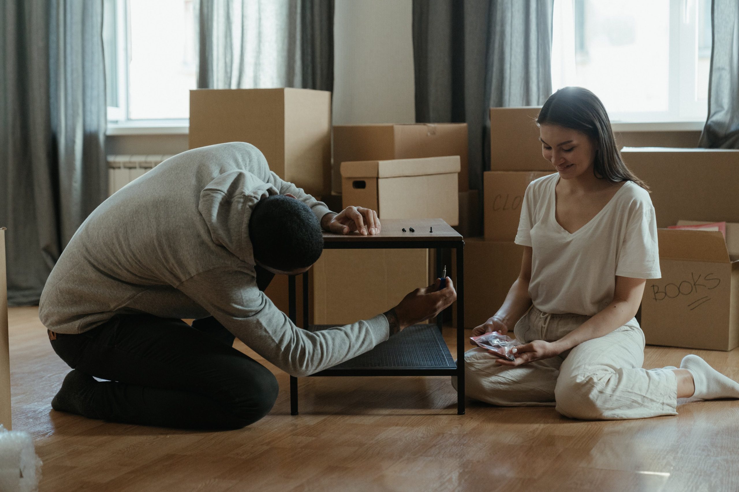 "A man using tools to dismantle furniture by using Disassembly Planning Efficiency."