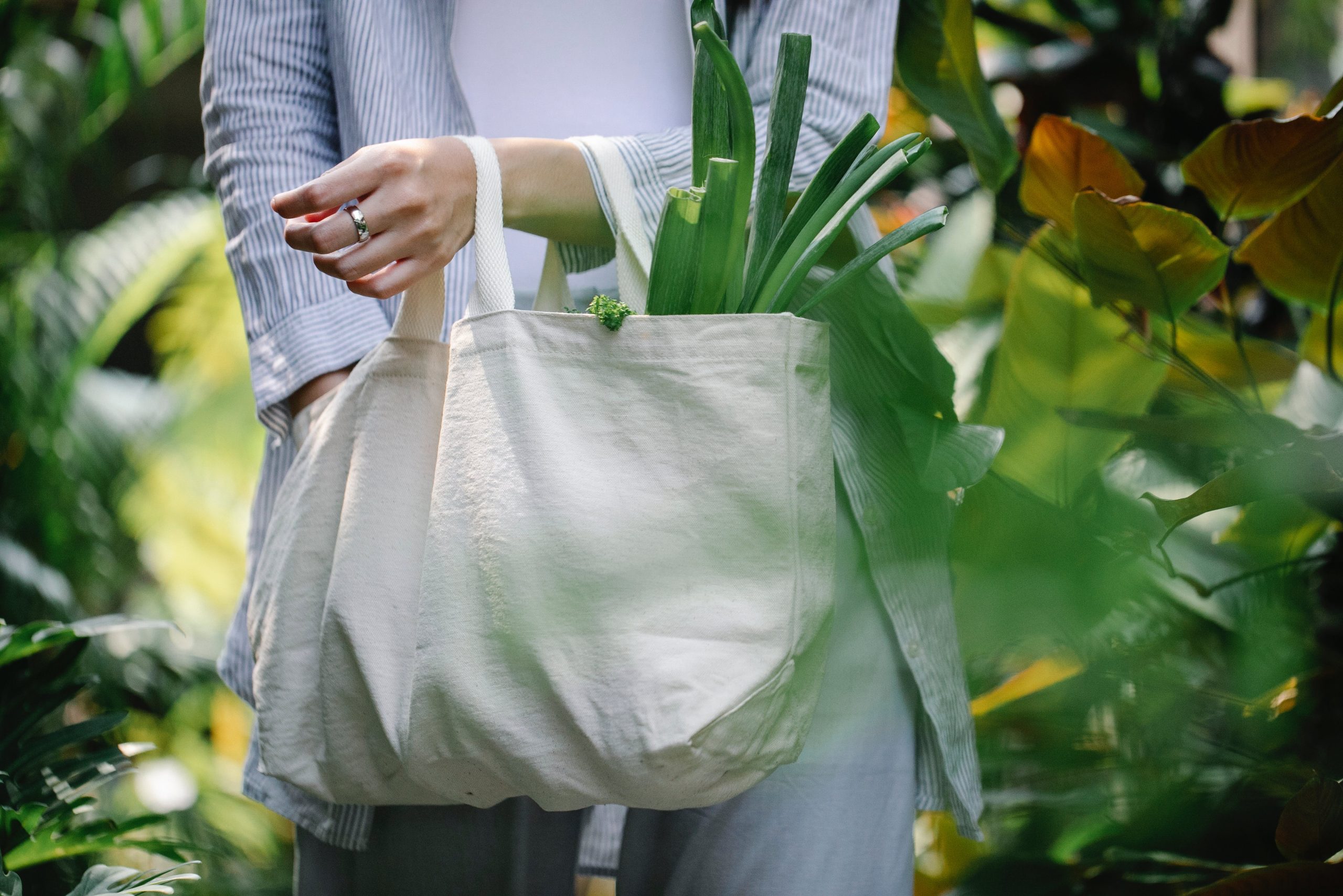 "Eco-friendly Packing: Sustainable packing with biodegradable materials and recycling symbols on boxes. Electric vehicle in the background represents green transportation during a conscientious relocation." 