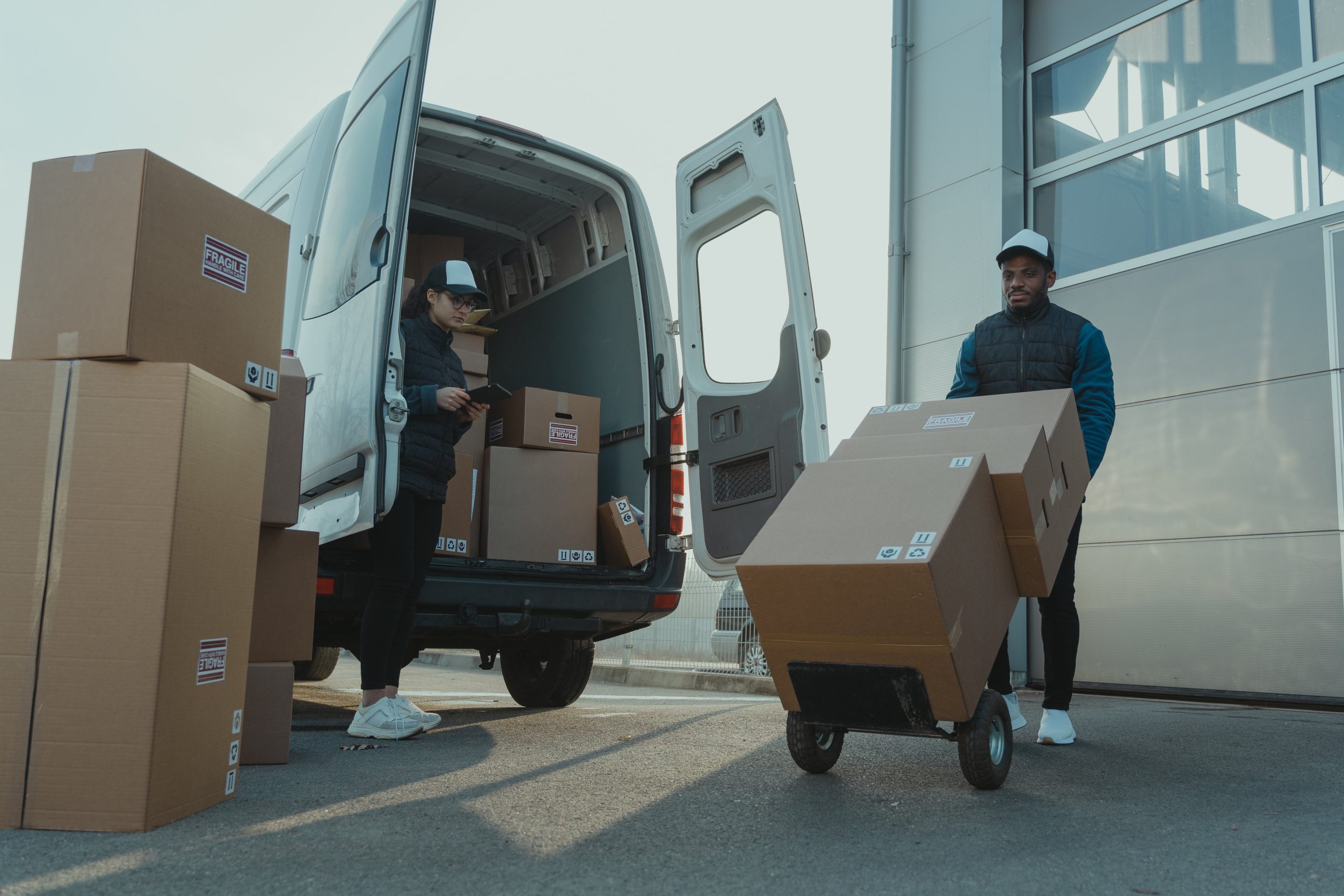  "Efficient moving team loading truck during Peak Season Challenges against a vibrant backdrop. Strategic organization signifies proactive planning for a smooth transition." 