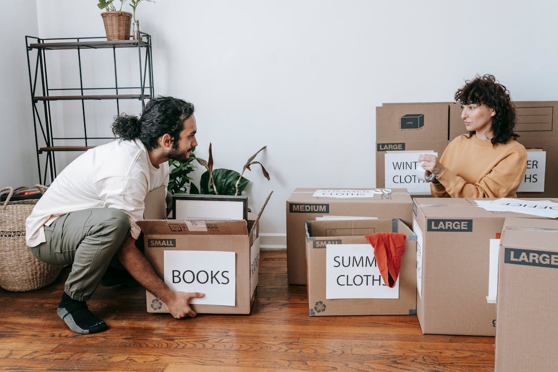 A happy family celebrating a successful move into their new home using moving hacks.