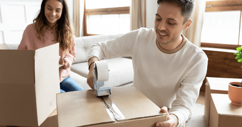 A couple is packing boxes and preparing to move.