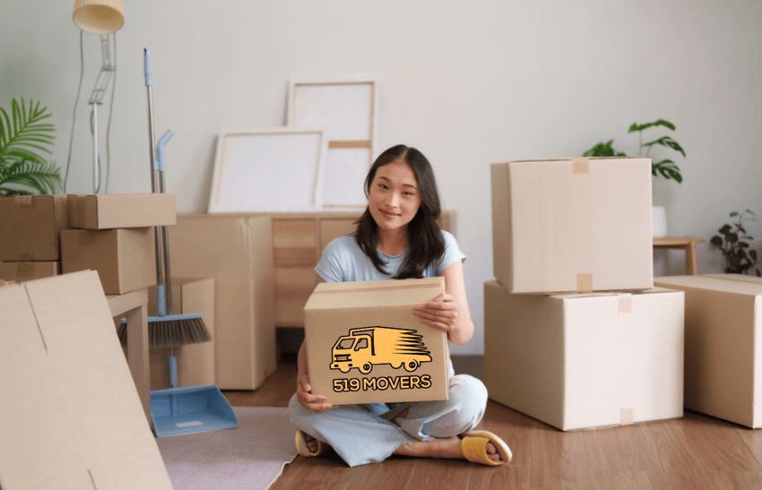A girl is packing belongings and several boxes are placed nearby, showcasing how to save money on moving in London Ontario.
