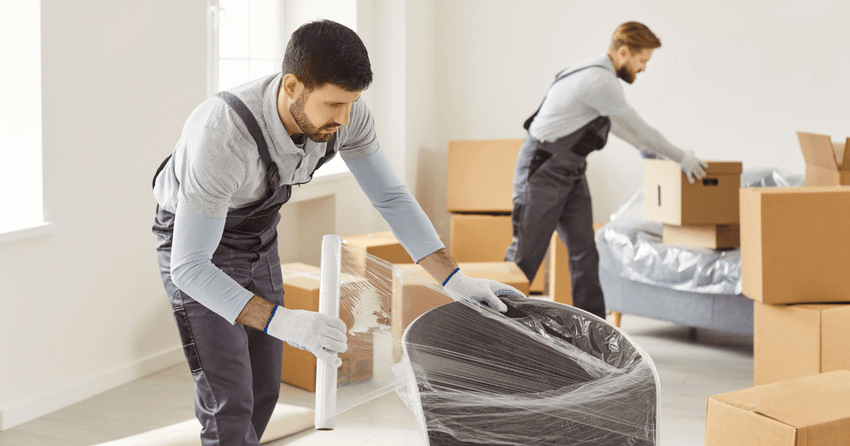 professional movers carefully packing home items.