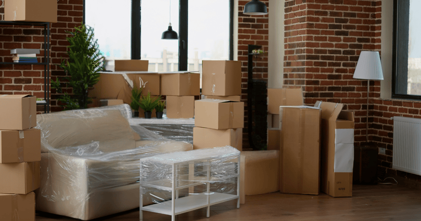 Apartment belongings packed and furniture protected before moving day.